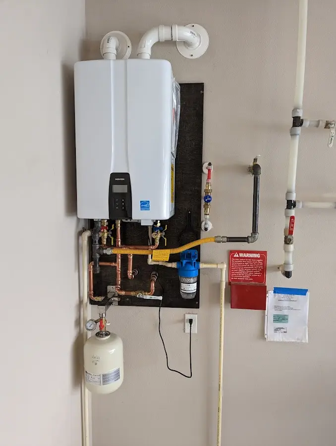 Professional plumber installing copper piping in a Scottsburg home